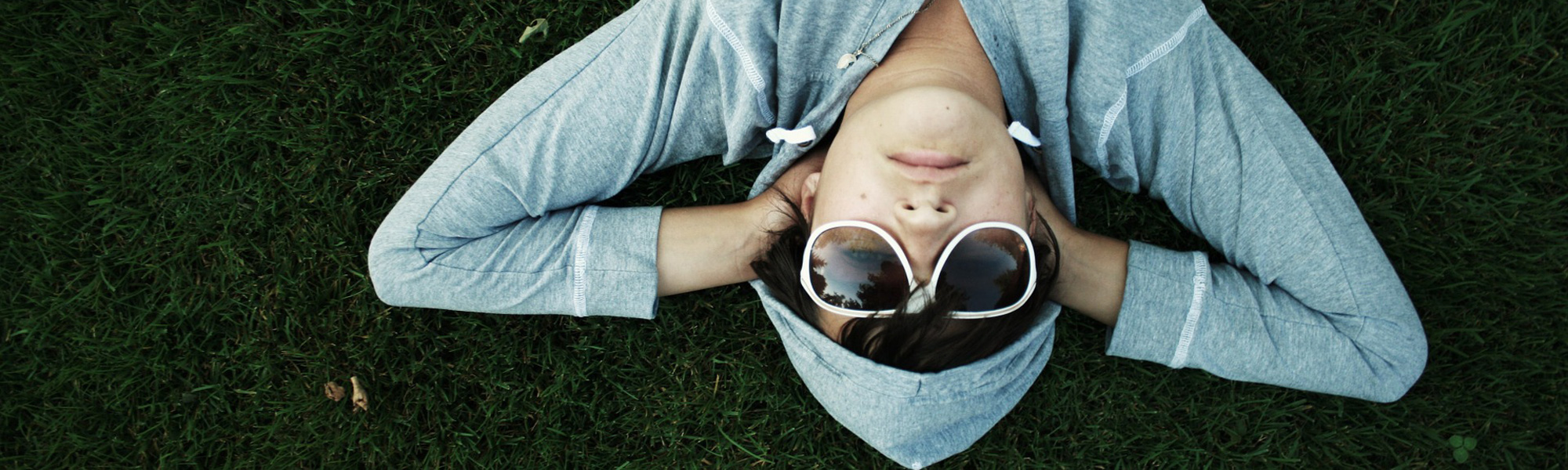 Man wearing sunglasses in the grass